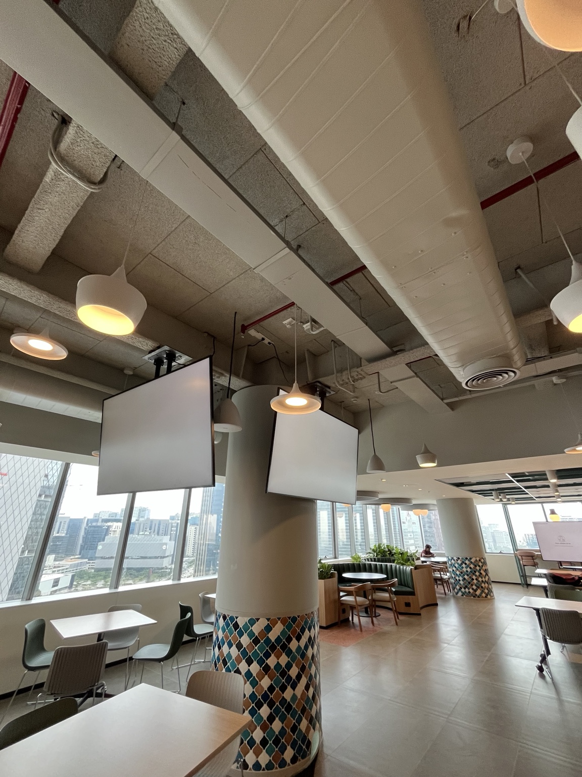 Suspended displays bring presentation capability into an open workplace environment.